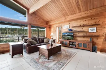 Living room, with custom wood shelves, and marina views.
