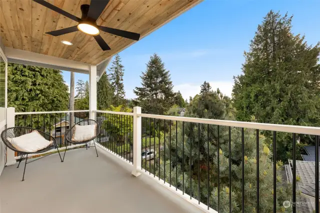 The primary level boasts a private, west-facing balcony with outdoor fans and calming wood accents.