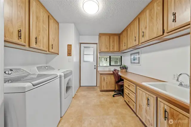 Large laundry room with access to outside. Work from home? Great desk with drawers and lots of storage.