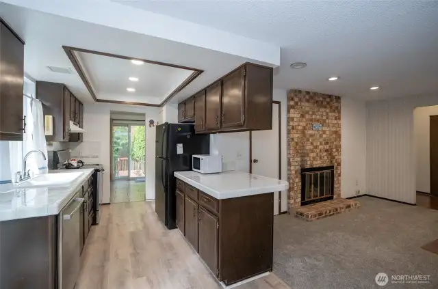 From the kitchen, easily access the family room to the right, complete with a warm gas fireplace for cozy gatherings.