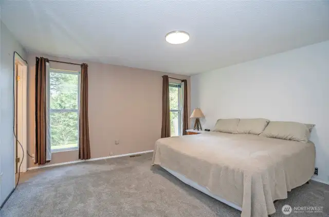 Primary suite featuring new carpet and impressive floor-to-ceiling windows that fill the room with natural light.