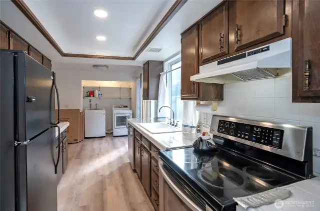 Kitchen offers low-maintenance laminate flooring, combining style and convenience.