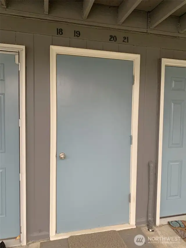 The door leads upstairs to four units at the landing.