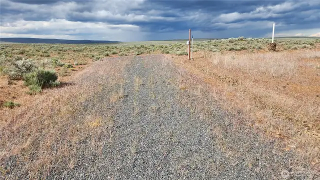 Graveled RV site, wired for solar power & plumbed to well for water