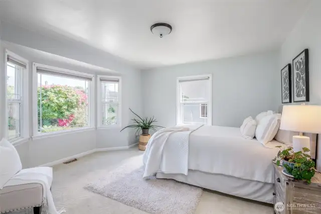 The beautiful bay windows offer so much light to this spacious main floor bedroom.
