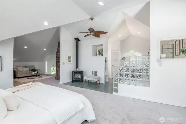 Entire upper level is a dreamy primary suite with a spa-like bathroom, vaulted ceilings, a freestanding gas stove, walk-in closet, new carpet & paint