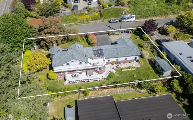 This seaside home is truly one-of-a-kind thanks to the stunning copper accents, original clinker brick and cedar shingled gables
