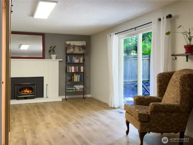 Family room with wood burning fireplace & slider out to patio & huge backyard.