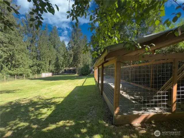 Huge, fully fenced backyard with patio, fire pit area & oversized dog kennel or chicken run.