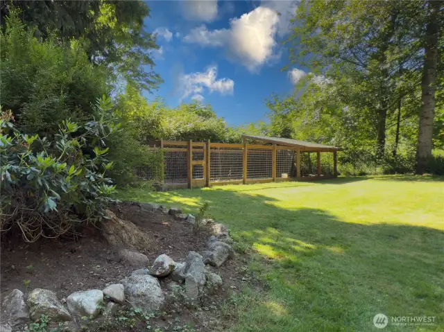 Huge, fully fenced backyard with patio, fire pit area & oversized dog kennel or chicken run.