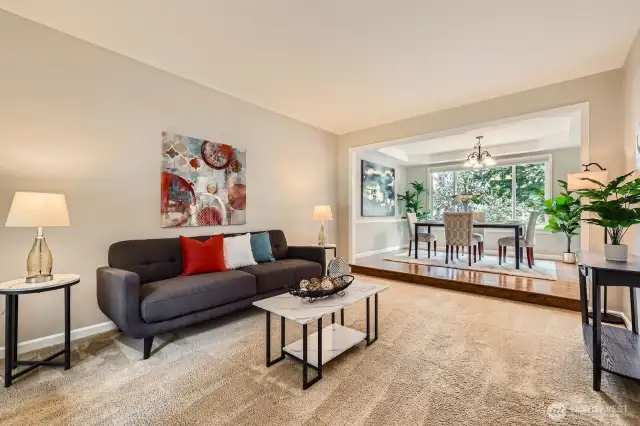 Living area opens to formal dining space. Neutral color palette, detailed trim, and flexible layout ideal for everyday living or entertaining.