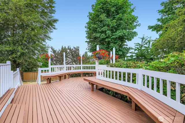 Generous deck design with integrated seating, perfect for gatherings, relaxing, or enjoying backyard views in all seasons.