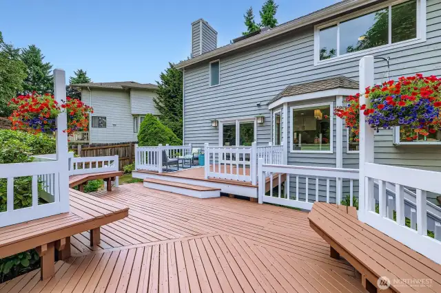 Beautifully designed multi-tiered deck offers separate spaces for dining, lounging, and socializing. Built-in benches, vibrant flower planter hooks, and seamless indoor-outdoor flow create an entertainer’s dream backyard retreat.