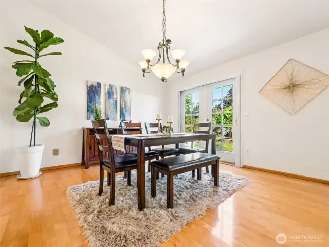 Vaulted ceilings add height to this space along with good lighting and the French Doors out to the backyard. (Room to add your sideboard or hutch!)