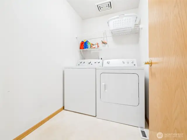 Spacious laundry room -- W&D stay! And note, there's room to add more shelving or cabinets.
