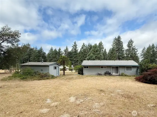 Left side of home with additional storage shed