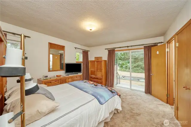 Master bedroom offers spacious comfort, with a half bath featuring enjoyable views and direct access to a private outdoor oasis.
