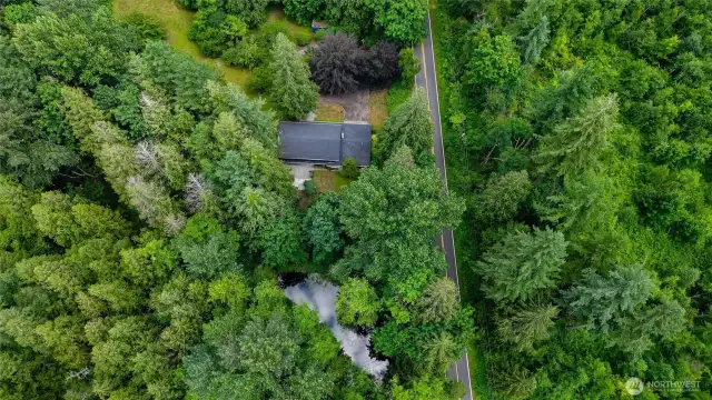 Situated on 5+ acres with a pond and creek
