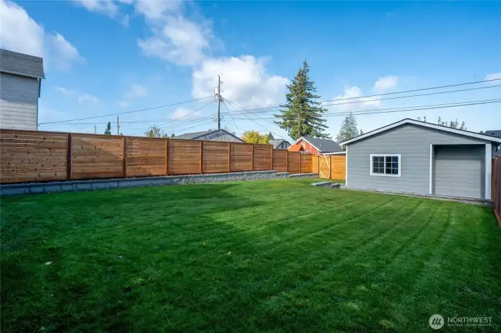 The fully fenced backyard features a detached garage that you can keep for parking OR convert to a future DADU since you have driveway parking.