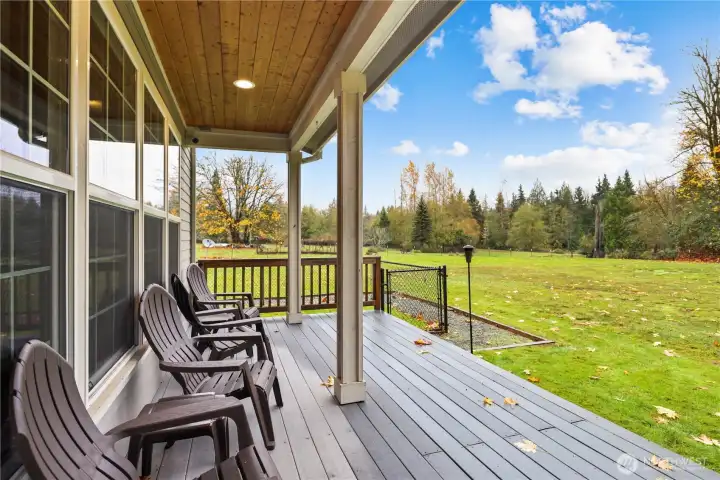 ...through the back doors to the left - bring your morning coffee outside.  Notice the fenced-in dog run already there for your pups!