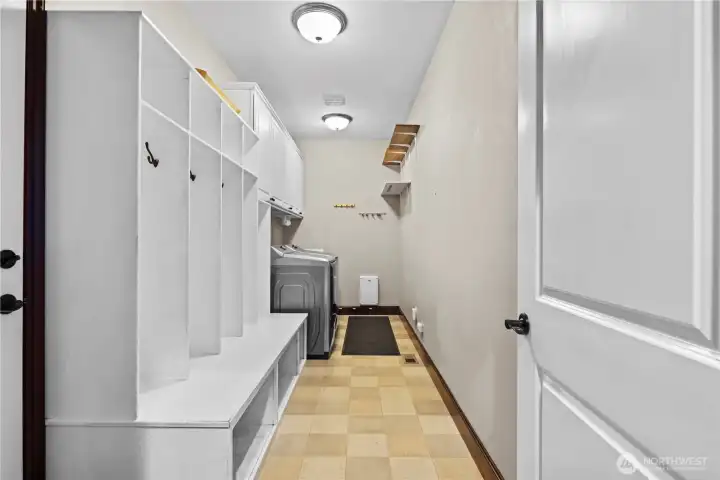Downstairs again, past the powder room is the laundry/mud-room