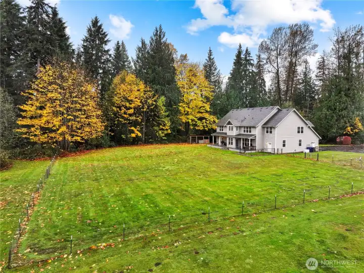 From the side property line - the fence on the left is just to keep the pets in; property extends into the woods to the left.