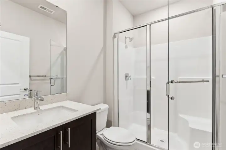 3/4 bath situated next to main floor bedroom, home for sale will include white cabinetry.