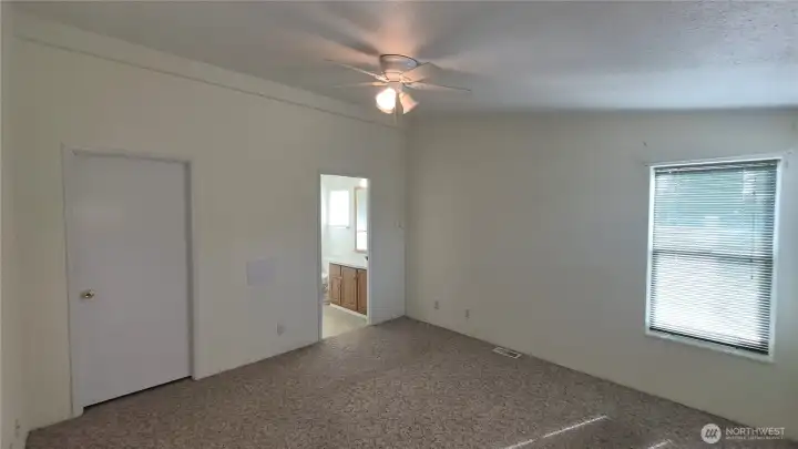 Main bedroom with walk-in closet and attached 3/4 bath.