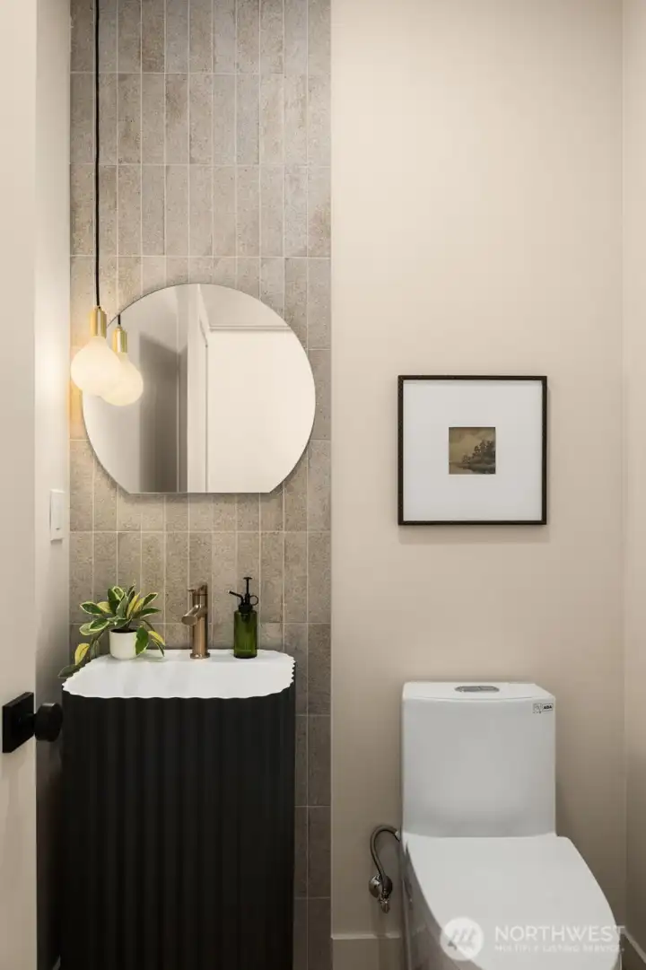 Convenient powder room, features texutred tile wall and modern vanity Convenient powder room, features texutred tile wall and modern vanity