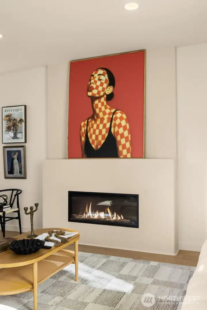 Statement fireplace creates a focol point, adding warmth, light, and a natural gathering space