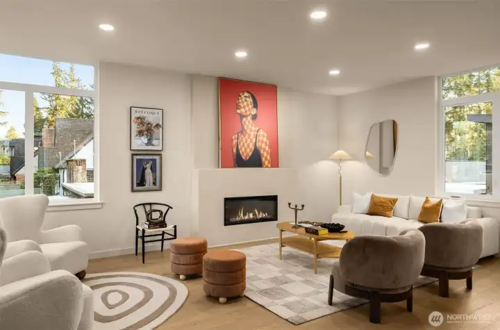 Large-scale windows frame the neighborhood while flooding the main level with soft, natural light.