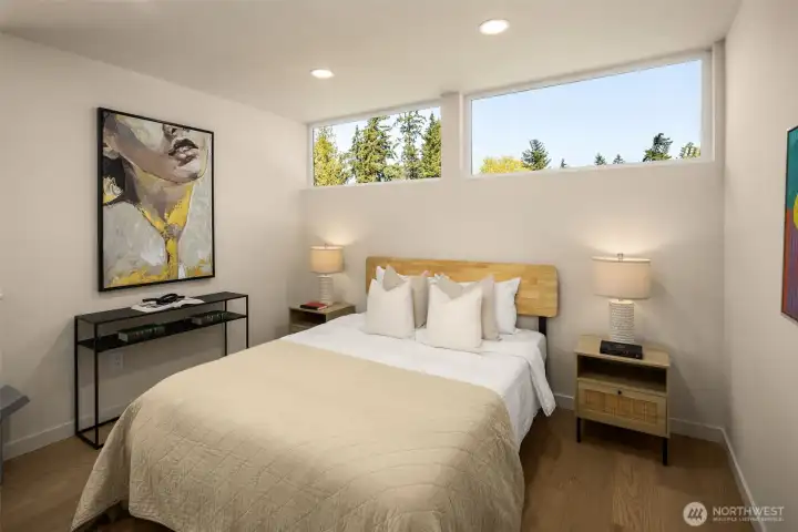 Additional bedroom contains high windows bringing in natural light