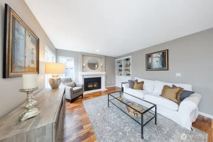 Warm and inviting main floor family room with gas fireplace, built-in shelving, and refined finishes throughout.