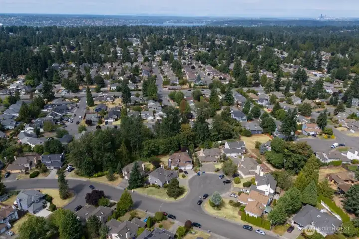 Expansive overhead view of the surrounding neighborhood with Seattle visible in the distance.