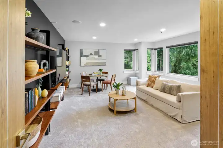 Large and inviting media room with Ryan Landworth Arch Blacksmith custom shelving.