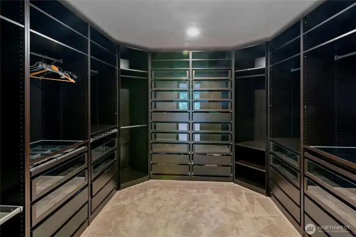 Primary closet with storage.