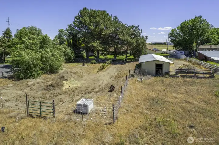 Separate fenced area. Healthy piles of soil. Barn shown to the right. Separate fenced areas.