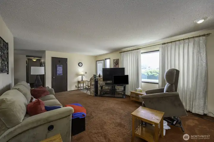 Living room looking at front door to the back right corner
