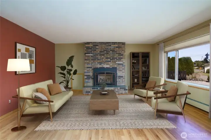 Virtually Staged.  The living room features plenty of room to gather around the gas fireplace and features easy care laminate floors.