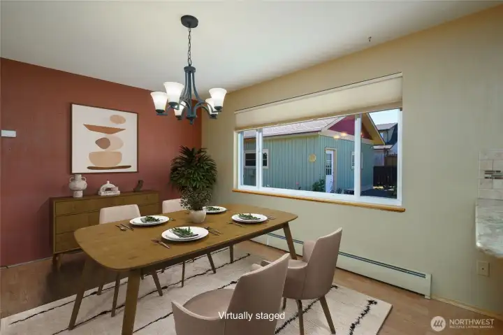 Virtually staged.  Dining room off the kitchen features gorgeous built in cabinetry and is open to the kitchen.