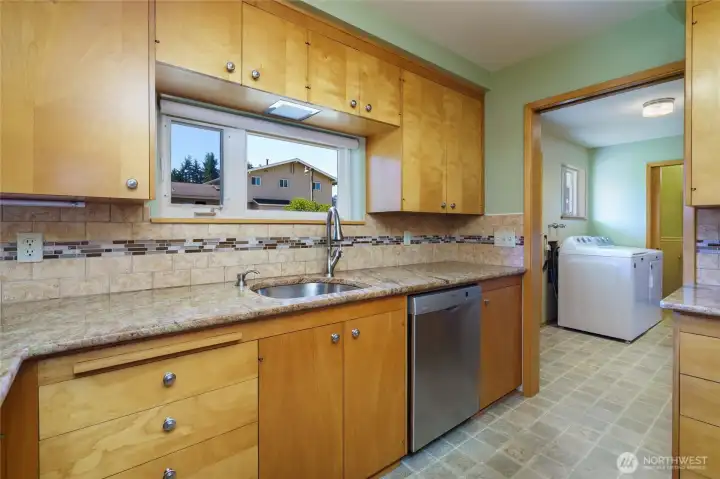 Kitchen has been refreshed with stainless appliances including a Bosch dishwasher, Frigidaire Microwave, gas stove and Refrigerator.  Beautiful granite countertops and backsplash create a striking addition to the gorgeous wood cabinets.