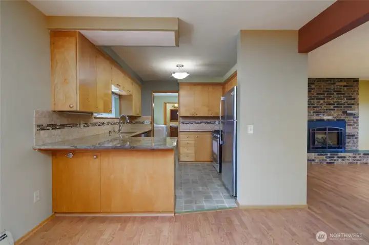 Kitchen features a eating bar and is open to the dining room.
