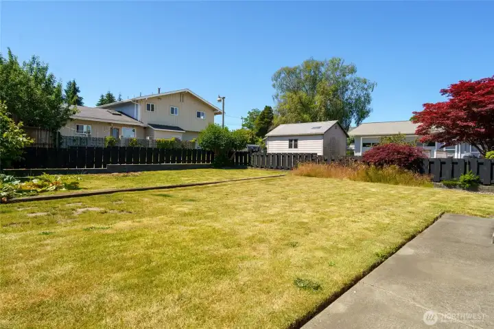 View of the back yard.  The area in the back was once a gorgeous garden. amazing veggies and flowers were grown.