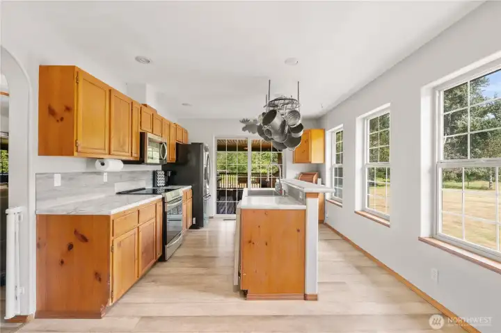 Sliding door opens to the large, covered deck for easy access to outdoor cooking. Sliding door opens to the large, covered deck for easy access to outdoor cooking.