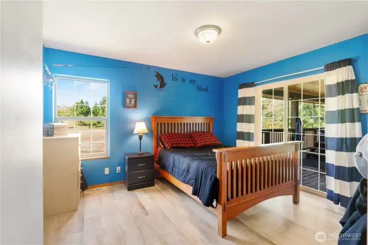 2nd bedroom on main floor offers sliding door out to the back deck and hot tub 2nd bedroom on main floor offers sliding door out to the back deck and hot tub