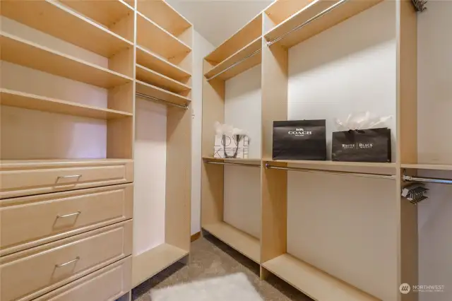 Shelving and drawers in your walk-in closet around the corner from the washer and dryer.