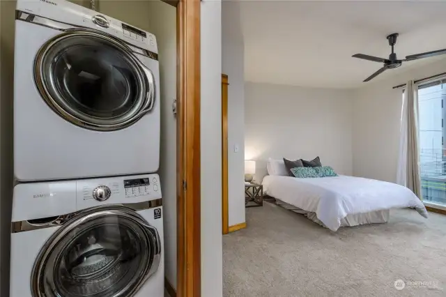 Full sized stack washer and dryer in a convenient location.