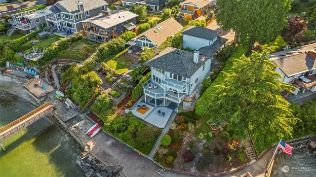 Its as if this home sits on a point. The other homes step back from it creating 180 degree views up and down the bay.