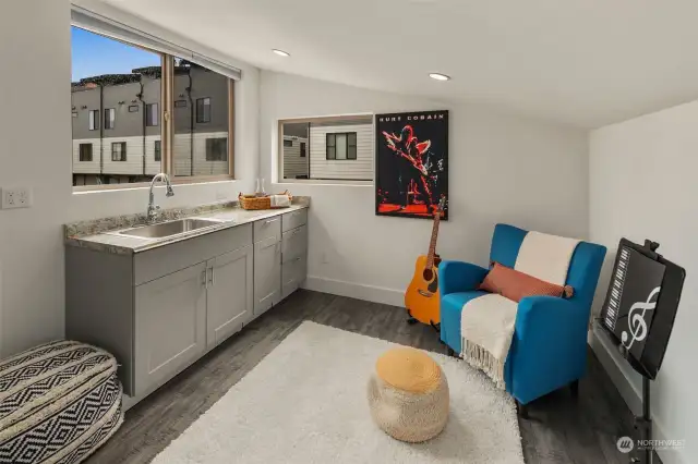 The studio above the garage features a counter with sink and storage, plus a 3/4 bath (not shown). Plenty of space for a music room, art studio, office or guest space!