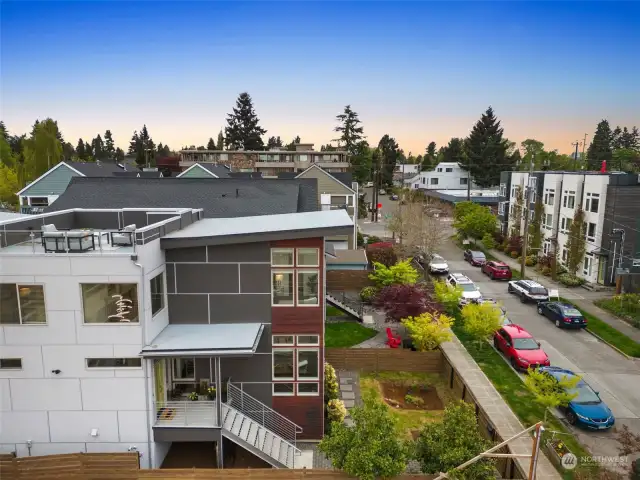 This aerial shot facing north shows the rooftop deck and some of the beautiful architectural details of the home.